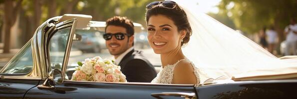 Joyful bride and groom in vintage convertible on sunny day after wedding ceremony photo