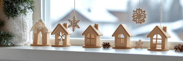 Winter decorations featuring wooden houses and snowflakes hanging in a cozy indoor setting photo