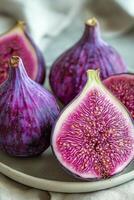 Freshly sliced figs displaying vibrant color and intricate texture on a dark background photo