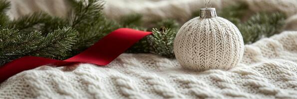 A beautifully knit blanket and a silver ornament resting on a holiday wreath in festive decor photo