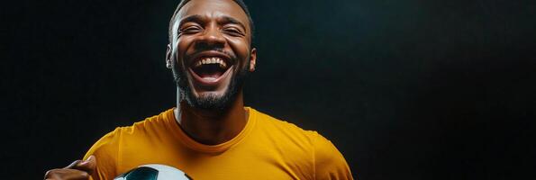 A soccer player passionately celebrating a goal in a dimly lit environment during a night match photo