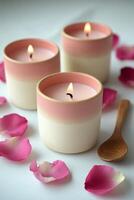 Tranquil ambiance with pink candles surrounded by rose petals on a simple surface photo