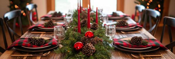 A beautifully decorated holiday dining table with pine branches and festive candles in winter photo