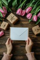 Celebrating a special occasion with gifts and fresh tulips on a gray surface in cozy attire photo