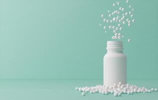 Various white pills spilled next to a glass bottle on a turquoise background at home photo