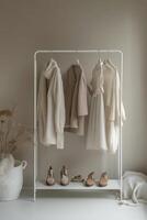 Stylish clothing rack with neutral coats and elegant shoes in a modern interior photo