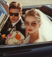 Elegant bride and groom in classic car on their wedding day with vintage style photo