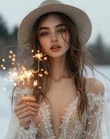 Girl in a straw hat celebrating with sparklers at a cozy, softly lit indoor gathering photo