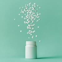 Brown glass bottle filled with tablets surrounded by scattered white pills on a green background photo