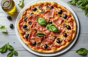 Delicious homemade pizza topped with basil, olives, and prosciutto on a wooden table photo