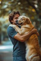 A man happily embraces his Labrador retriever in a sunny park during autumn photo