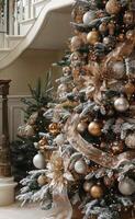 Festively decorated Christmas tree with gold ornaments in a cozy living room setting photo