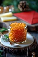 Fresh salmon roe served in a jar with herbs on a wooden board during daylight hours photo
