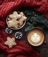 Warm holiday treats with gingerbread cookies and a steaming cup of coffee on a cozy knit backdrop photo