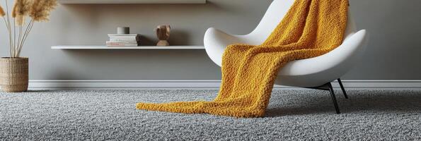 Cozy living room corner featuring a white chair and a warm yellow blanket on a bright afternoon photo