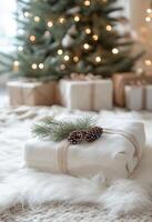 Cozy holiday gift wrapped in white fabric with pinecones, placed near a decorated Christmas tree photo