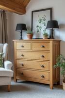 Elegant wooden chest of drawers beside a stylish lamp and indoor plant in a cozy living room photo