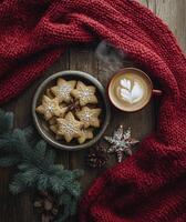 Warm holiday treats with gingerbread cookies and a steaming cup of coffee on a cozy knit backdrop photo