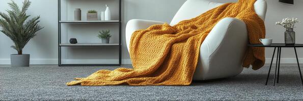 Cozy living room corner featuring a white chair and a warm yellow blanket on a bright afternoon photo