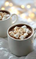 Cozy cups of hot chocolate with marshmallows on a soft blanket during a warm winter evening photo
