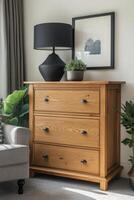 Elegant wooden chest of drawers beside a stylish lamp and indoor plant in a cozy living room photo
