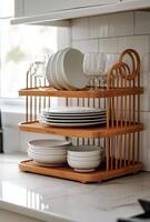 Elegant bamboo dish rack with glassware and ceramic bowls in a cozy kitchen setting photo