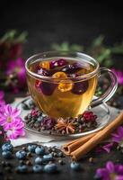 Aromatic herbal tea with dried fruits and spices surrounded by vibrant flowers and berries photo