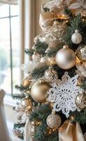 Festively decorated Christmas tree with gold ornaments in a cozy living room setting photo
