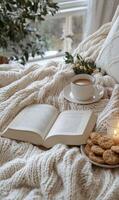Cozy reading nook with cookies, tea, and a candle by the window on a fall afternoon photo