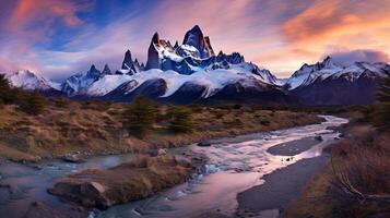 The mountains are covered in snow at sunset photo