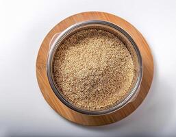 Small container containing quinoa grains, placed in the center of a white background photo