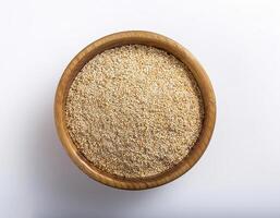 Small container containing quinoa grains, placed in the center of a white background photo