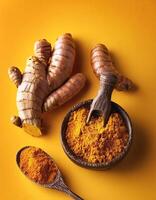 Turmeric and ginger on yellow background photo