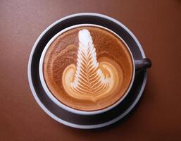 Cappuccino coffee with foam latte art on brown background photo