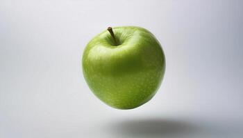 Green apple floating in the air on a clean white background photo