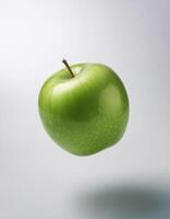 Green apple floating in the air on a clean white background photo