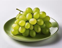 A plate of shiny green grapes on a clean white background photo