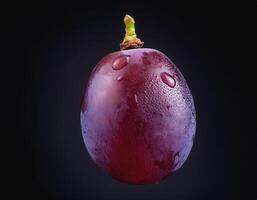 One purple grape isolated on a black background, showing the details of the skin and texture photo