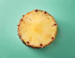 One slice of pineapple on a mint background photo