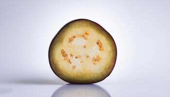 One slice of purple eggplant isolated, showing its rich texture and color photo