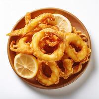 Fried squid rings with lemon slices on a plate photo