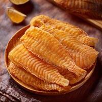 Fried fish fillets on a wooden plate photo