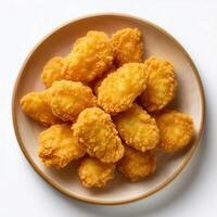 A plate of fried chicken nuggets on a white background photo