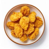 A bowl of fried chicken nuggets on a white background photo