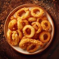 A plate of fried onion rings on a table photo