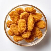 A bowl of fried chicken nuggets in a clear bowl photo