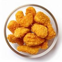 A bowl of fried chicken nuggets on a white background photo