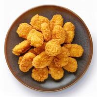 A plate of fried chicken nuggets on a white background photo