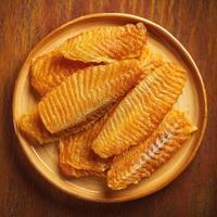 Fried fish fillets on a wooden plate photo