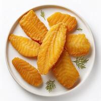 A plate of fried fish on a white surface photo